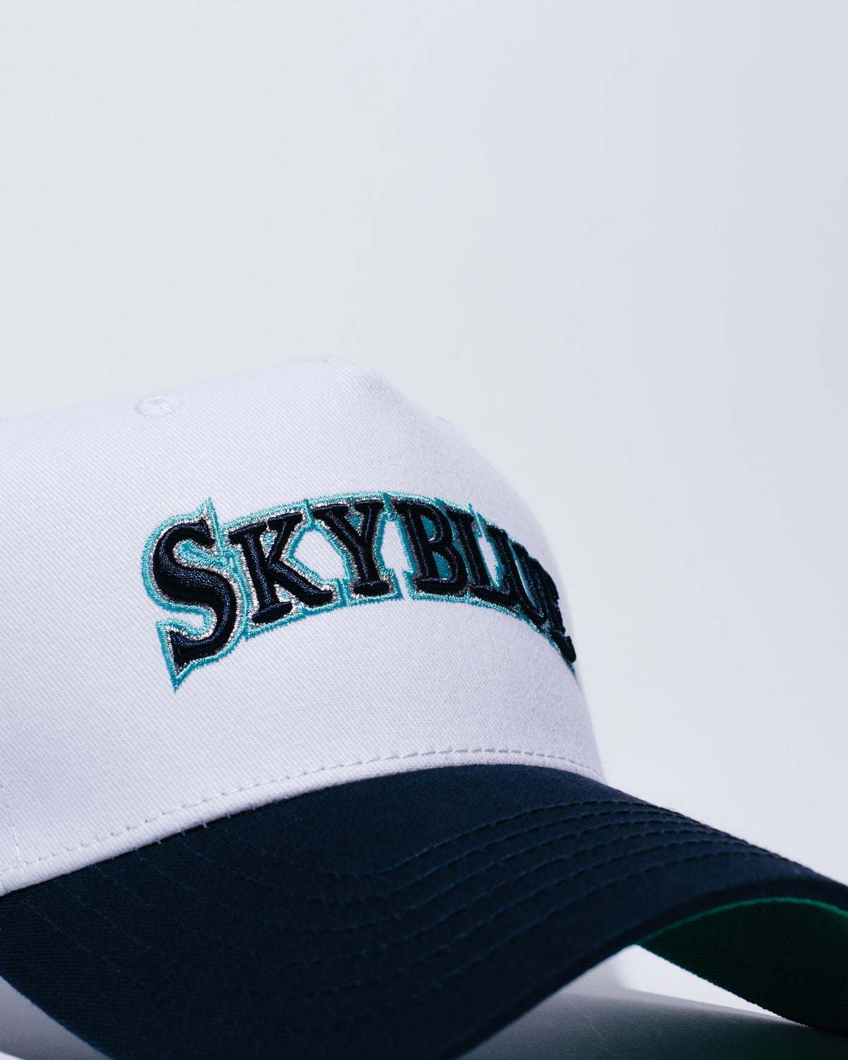 White and navy Skyblue wordmark snapback
